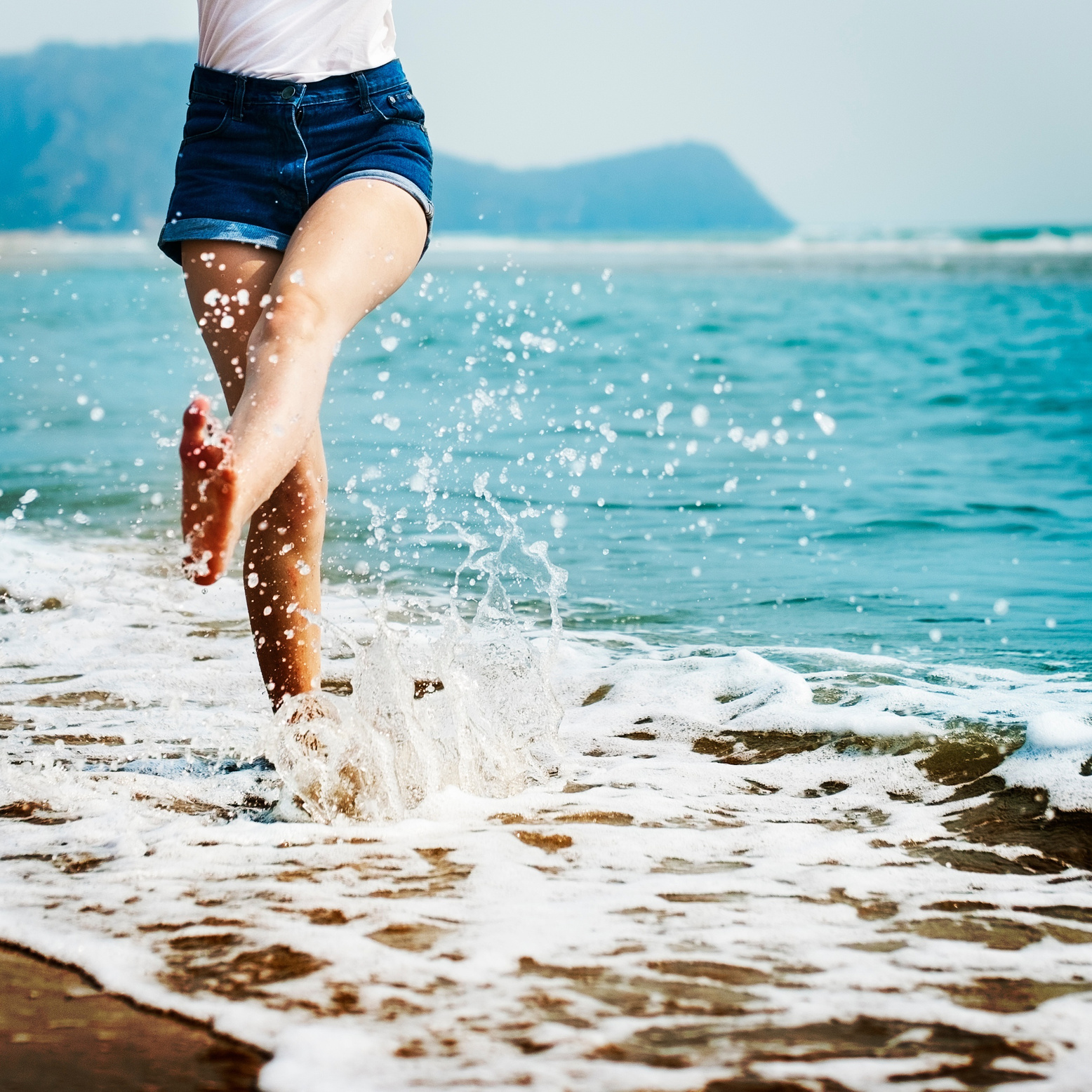 Woman Playing Around with Ocean Water